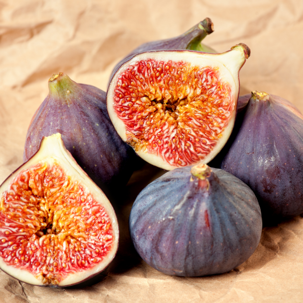 fresh figs in a pile with one cut in half